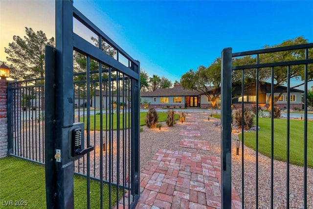 gate at dusk with a yard