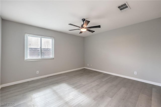 spare room featuring ceiling fan and light hardwood / wood-style floors