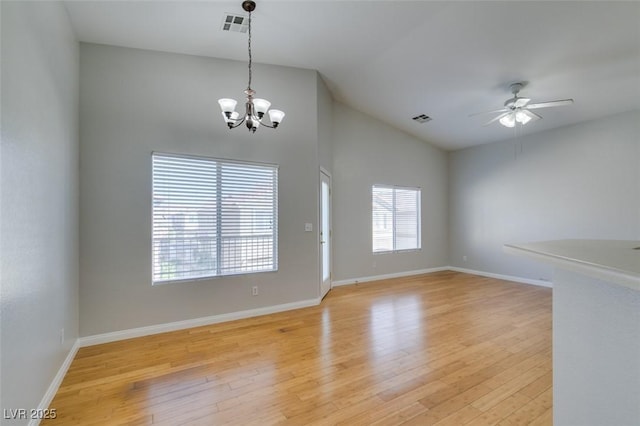 interior space featuring lofted ceiling, ceiling fan with notable chandelier, and light hardwood / wood-style floors