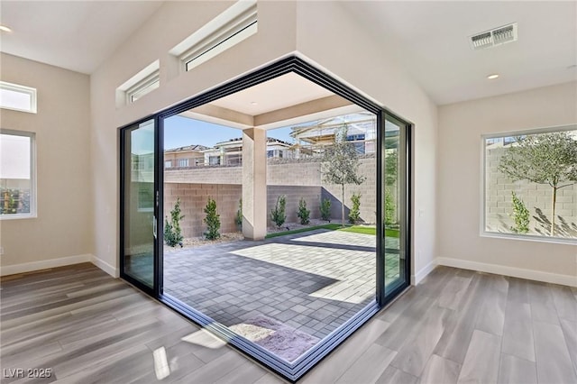 entryway with hardwood / wood-style floors