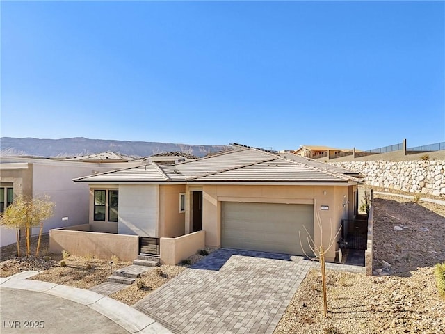 view of front of home with a garage and a mountain view