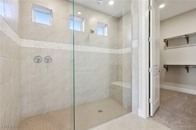 bathroom with tile patterned floors and a tile shower