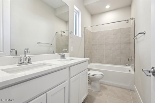 full bathroom with vanity, tiled shower / bath combo, tile patterned floors, and toilet