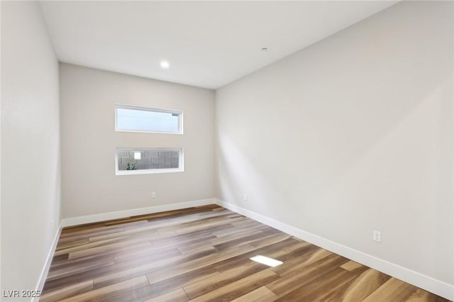 empty room with hardwood / wood-style flooring