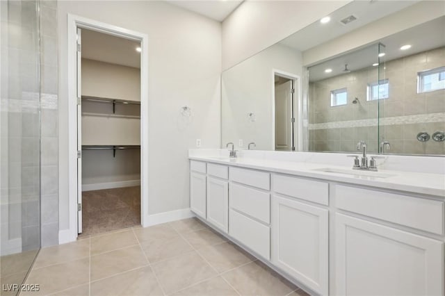 bathroom featuring vanity, tile patterned floors, and walk in shower