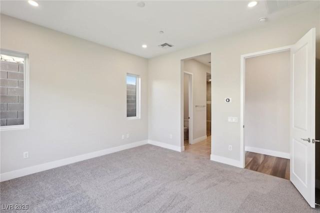 unfurnished bedroom with light carpet