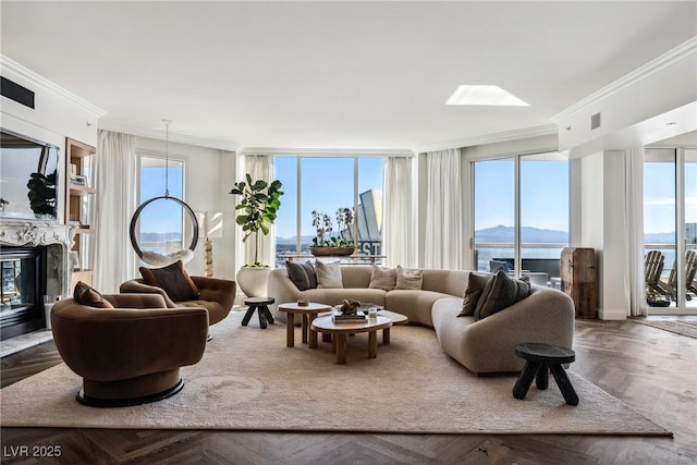 living room featuring parquet floors, crown molding, and a premium fireplace