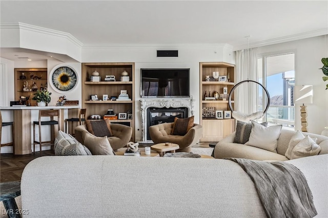 living room featuring dark parquet flooring, ornamental molding, and a premium fireplace