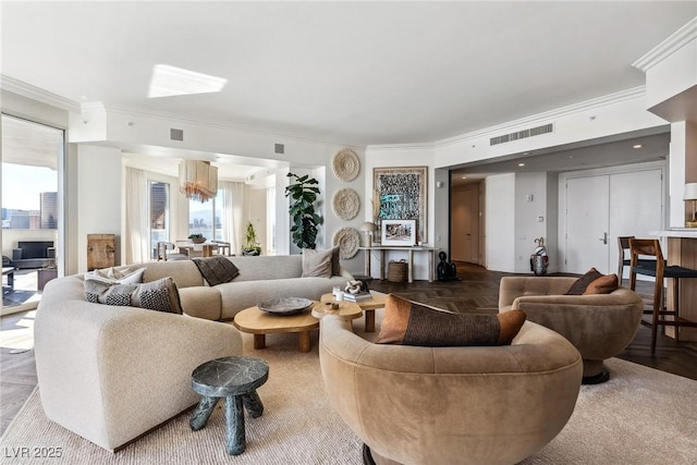 living room with crown molding and parquet floors