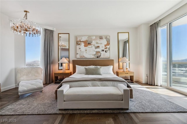 bedroom featuring parquet floors, access to exterior, and an inviting chandelier