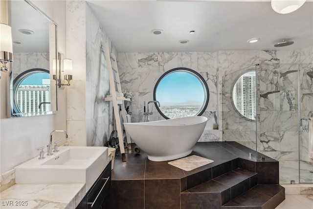 bathroom with vanity, independent shower and bath, and tile walls