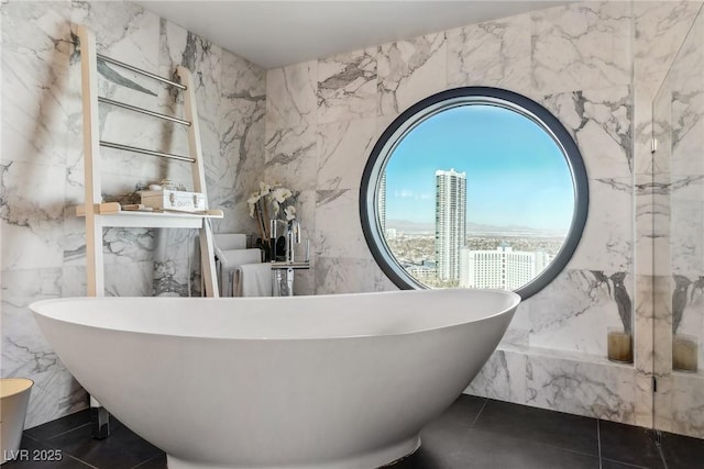 bathroom featuring tile walls, a bath, and tile patterned floors