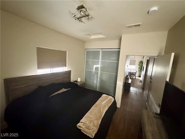 bedroom featuring dark hardwood / wood-style flooring and a closet