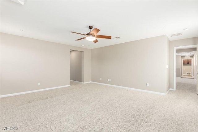 carpeted spare room featuring ceiling fan