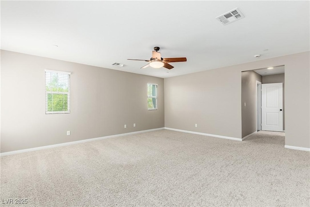 spare room with light carpet and ceiling fan