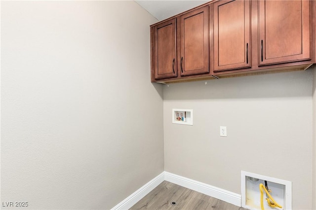 clothes washing area featuring hookup for a washing machine, light wood-type flooring, and cabinets