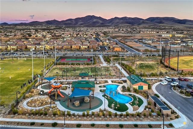 aerial view at dusk featuring a mountain view