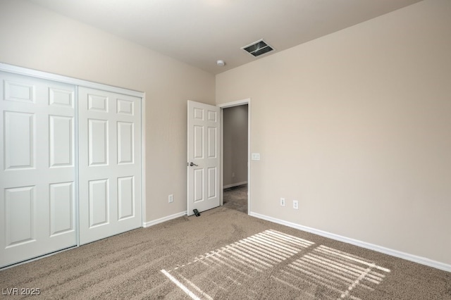 unfurnished bedroom featuring carpet flooring and a closet