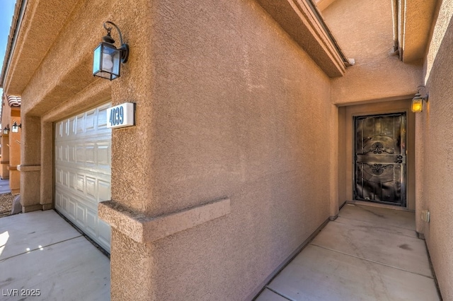 doorway to property with a garage