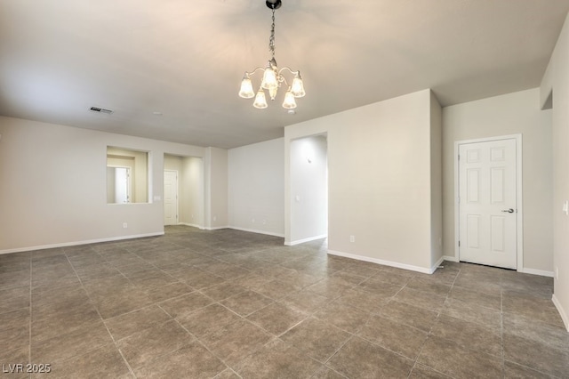 spare room with a chandelier