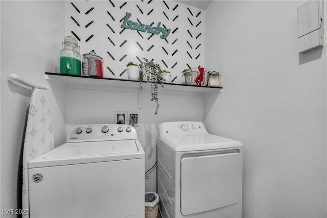 clothes washing area with separate washer and dryer