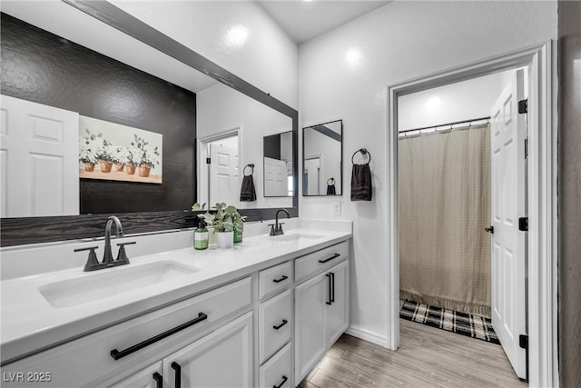 bathroom featuring wood-type flooring, vanity, and a shower with curtain