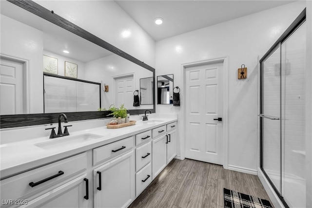 bathroom featuring vanity and an enclosed shower