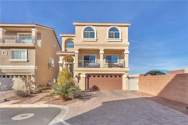 mediterranean / spanish-style house with a garage and a balcony