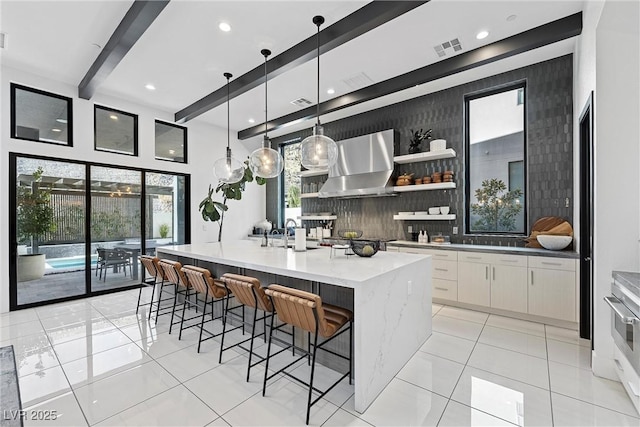 kitchen featuring white cabinetry, decorative light fixtures, beamed ceiling, range hood, and decorative backsplash