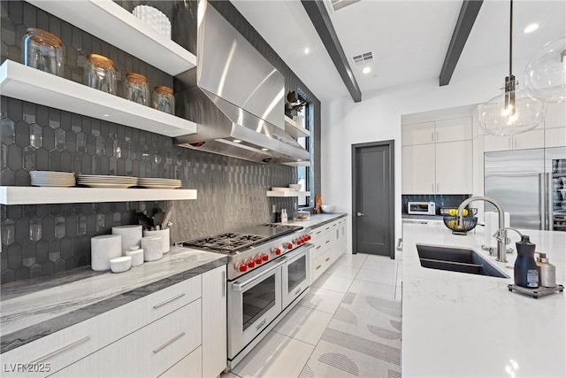 kitchen featuring high quality appliances, sink, white cabinets, exhaust hood, and beam ceiling