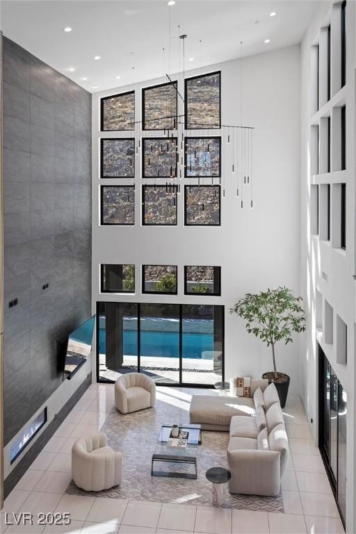 tiled living room with a towering ceiling