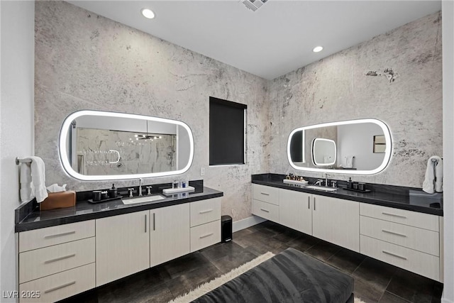 bathroom with vanity and a shower