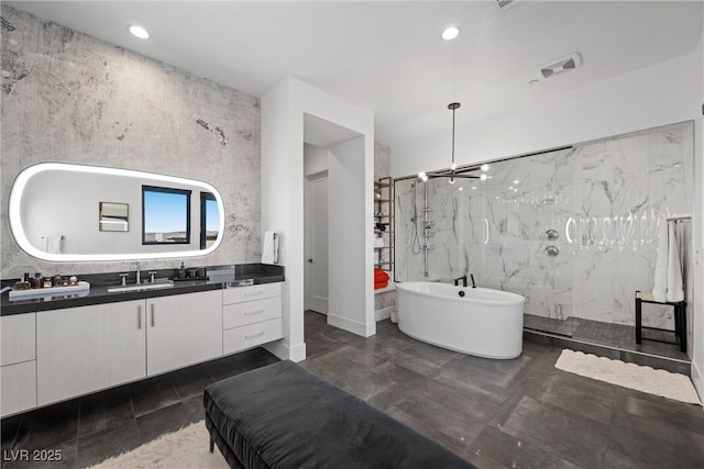 bathroom featuring vanity, tile walls, and separate shower and tub