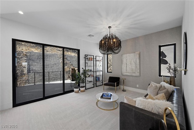 living room with an inviting chandelier and carpet flooring