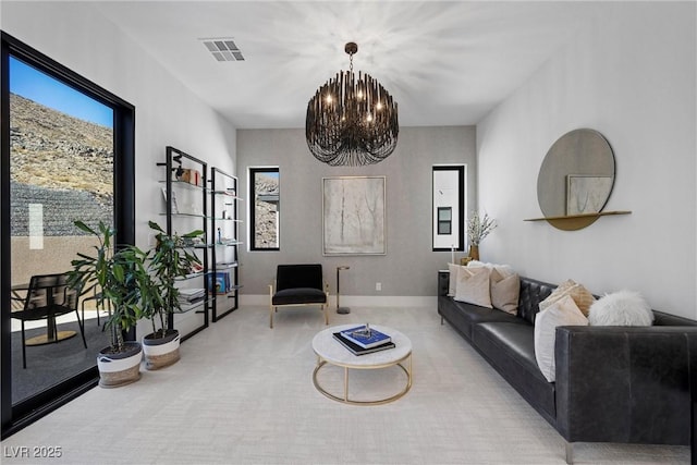 living room featuring carpet and a chandelier