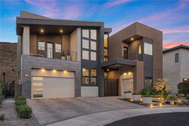 contemporary home featuring a garage and a balcony