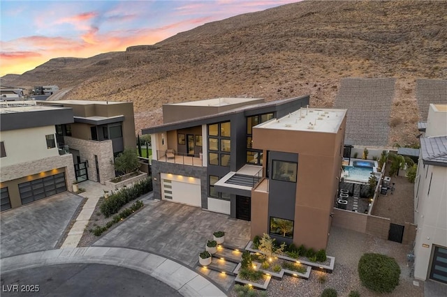 contemporary house with a garage and a mountain view