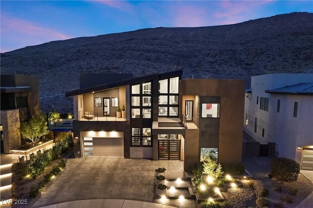 contemporary home with a garage and a mountain view