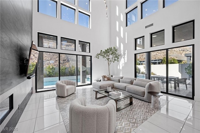 tiled living room featuring a towering ceiling