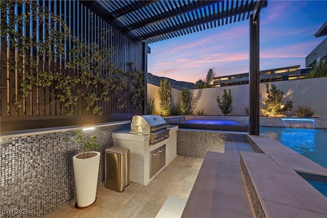 patio terrace at dusk featuring an outdoor kitchen, area for grilling, pool water feature, a pergola, and a fenced in pool