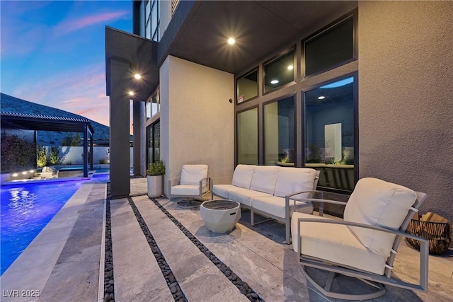 patio terrace at dusk featuring a swimming pool with hot tub, outdoor lounge area, and a pergola