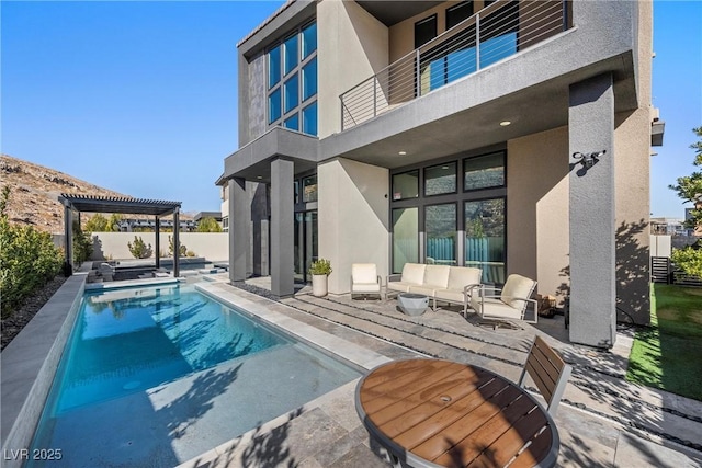 back of house featuring a patio, a balcony, outdoor lounge area, and a pergola