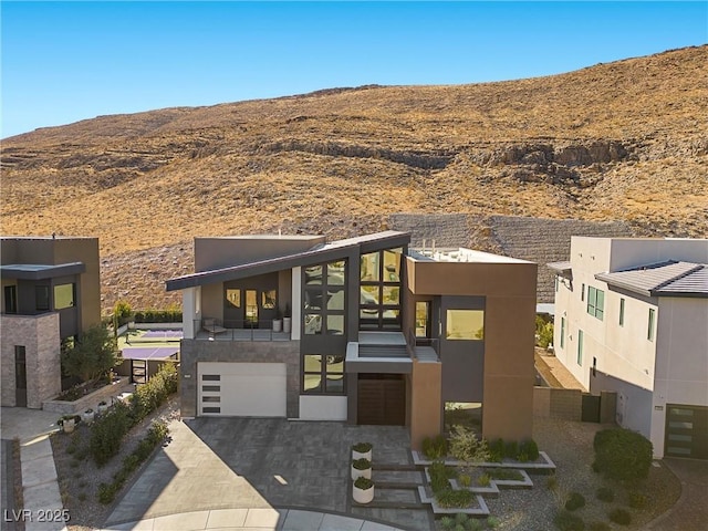 modern home with a garage and a mountain view