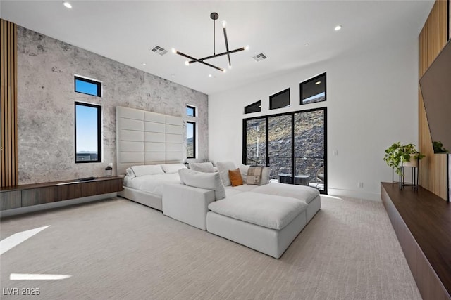 carpeted living room featuring an inviting chandelier