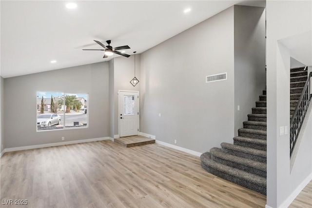 foyer with ceiling fan, lofted ceiling, and light hardwood / wood-style floors