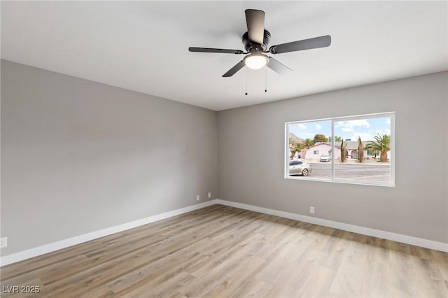 empty room with light hardwood / wood-style floors and ceiling fan