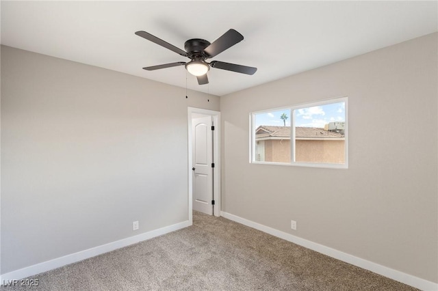 spare room featuring ceiling fan and light colored carpet