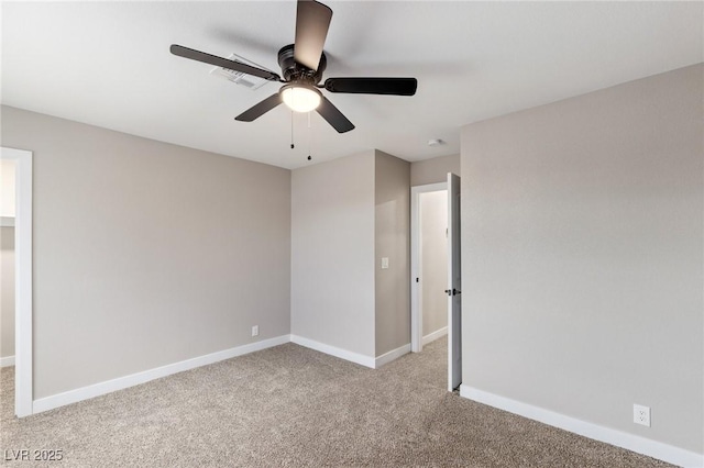 empty room with ceiling fan and light colored carpet