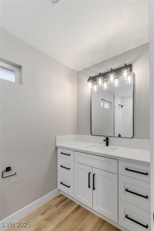 bathroom featuring hardwood / wood-style flooring and vanity