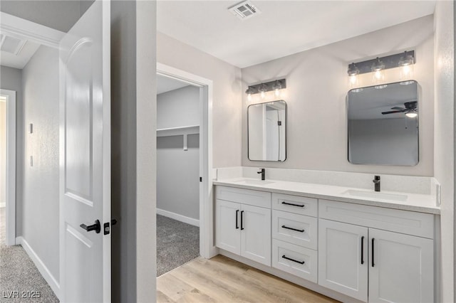 bathroom with vanity, hardwood / wood-style floors, and ceiling fan